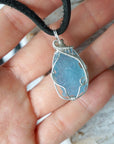 Raw aquamarine necklace in hand for size reference, artisan wire wrapped, 925 sterling silver, men's necklace