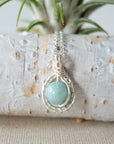 Back angle of aquamarine necklace, showing wire wrapped setting and fine silver plated chain