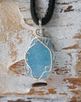 Close-up of raw aquamarine pendant front, artisan wire wrapped in 925 sterling silver, men's necklace