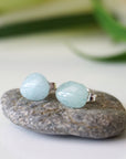 Detailed front view of aquamarine stud earrings, raw natural stones on sterling silver posts, gender neutral, Designs by Nature Gems