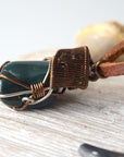 Close-up of artisan wire wrapping on natural bloodstone necklace, handcrafted by Designs by Nature Gems.