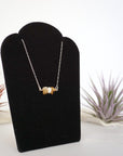 Right side angle of citrine and pearl bar necklace full length showing sterling silver 925 chain and horizontal pendant - natural crystal pearl wire wrapped jewelry