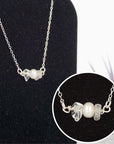 Close-up of raw clear quartz stones and freshwater pearl bar on 925 sterling silver necklace