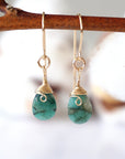 Detailed front view of emerald drop earrings, genuine faceted emerald with minimalist 14k gold filled wire wrapping, Designs by Nature Gems