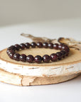 Garnet beaded bracelet made with natural 8mm garnet beads on a stretch cord, shown as a full view