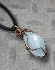 Right side angle of men's aquamarine pendant necklace, genuine aquamarine, antique bronze copper wire wrapping, leather cord