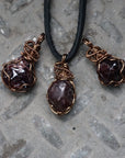Three natural garnet pendants showing variation in size, shape, and color, allowing customers to choose their men’s wire wrapped garnet necklace