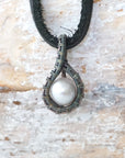 Men’s pearl pendant necklace with a natural freshwater pearl on a black leather cord, shown in full view