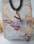 Back view of antique bronze copper wire wrapped raw amethyst pendant on black leather cord, men’s February birthstone necklace