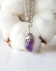 Back side angle of minimalist amethyst necklace, silver plated copper wire wrapped raw amethyst pendant