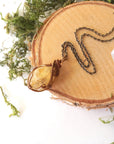Natural citrine necklace laying flat on antique bronze copper chain - handmade wire wrapped crystal pendant full view vintage boho jewelry for women November birthstone