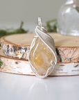 Front view of natural citrine pendant showing crystal texture and wire wrapping - silver plated copper handmade November birthstone necklace detail minimalist