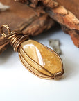Side angle of natural citrine pendant showing crystal dimension and wire wrap detail - antique bronze copper handmade unisex necklace for women men profile view