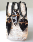 Three men’s black obsidian arrowhead pendants with antique bronze copper wire wrap, showing natural crystal variations, by Designs by Nature Gems.