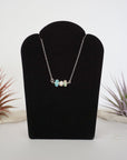 Opal and freshwater pearl bar necklace in 925 sterling silver on jewelry display, front view