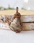 Back angle view of natural opal pendant, artisan wire wrapped jewelry by Designs by Nature Gems.