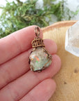 Natural opal pendant shown in hand for size reference, artisan jewelry by Designs by Nature Gems.