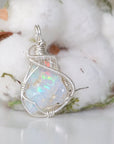 Right side angle detail of sterling silver opal pendant, wire wrapped by Designs by Nature Gems.