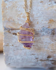 Back view detail of raw amethyst point pendant necklace with detailed gold plated copper wire wrap on gold plated brass chain