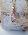 Front view of raw amethyst point necklace with detailed gold plated copper wire wrap on gold plated brass chain