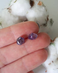 Raw amethyst stud earrings in hand for size reference, natural unpolished amethyst, sterling silver posts