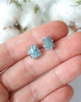 Raw aquamarine stud earrings shown in hand for size reference. Artisan March birthstone earrings by Designs by Nature Gems