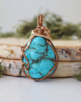 Back view raw turquoise pendant showing complete wire wrap and bail detail
