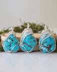Three raw turquoise pendants showing natural stone color and shape variations