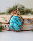 Front view raw turquoise pendant with detailed bronze gold wire wrapping art