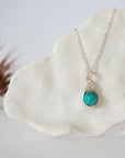 Silver plated turquoise pendant necklace front view showing wire wrapped stone