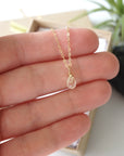 Small citrine pendant held in hand showing 0.5 inch size delicate 14k gold filled necklace for women