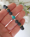 Turquoise lava bead mala bracelet with pyrite held in hand size view