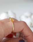 Woman wearing adjustable citrine ring 14k gold vermeil on finger - natural crystal wire wrapped handmade ring November birthstone styled on hand