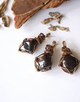 Three natural garnet pendants showing variation in size, shape, and color, allowing customers to choose their women’s wire wrapped garnet necklace