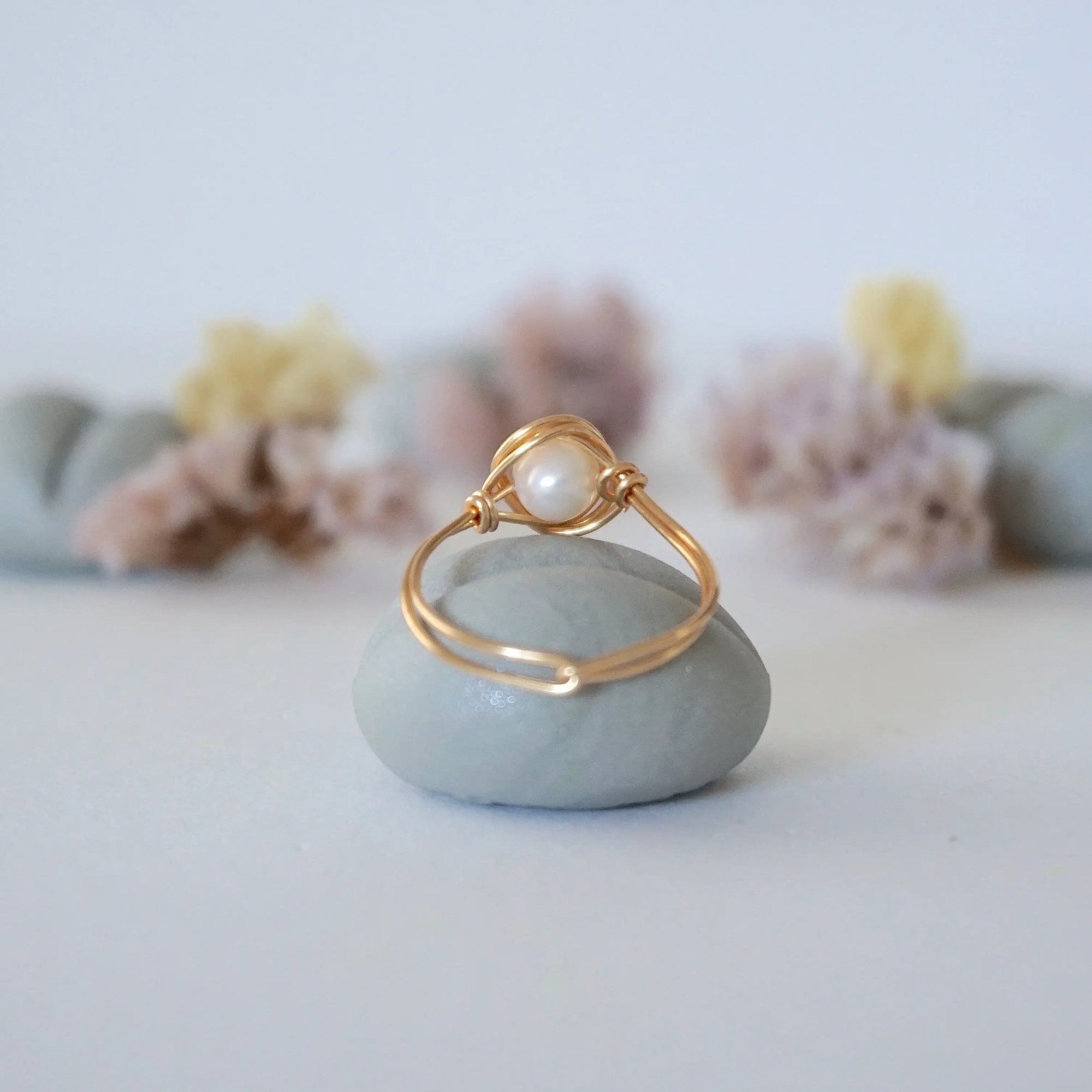 Back view of a minimalist pearl ring crafted in 14k gold filled wire