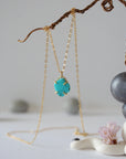 14k gold vermeil turquoise necklace close up showing claw setting and raw stone detail