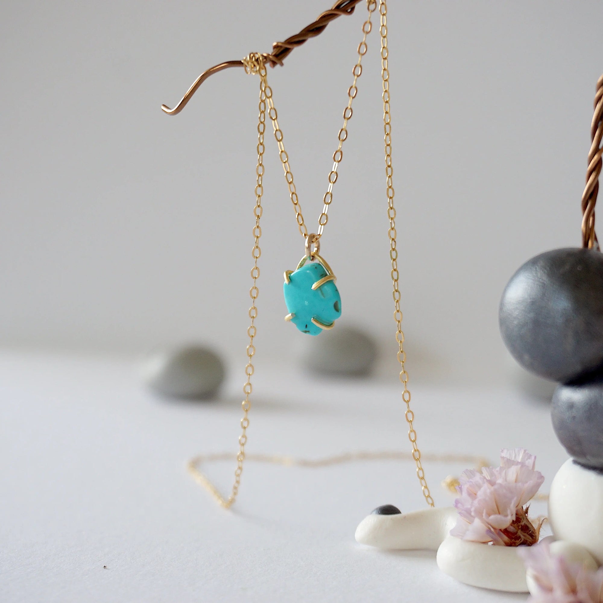 Side angle view of 14k gold vermeil turquoise necklace showing stone depth profile