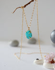 Side angle view of 14k gold vermeil turquoise necklace showing stone depth profile