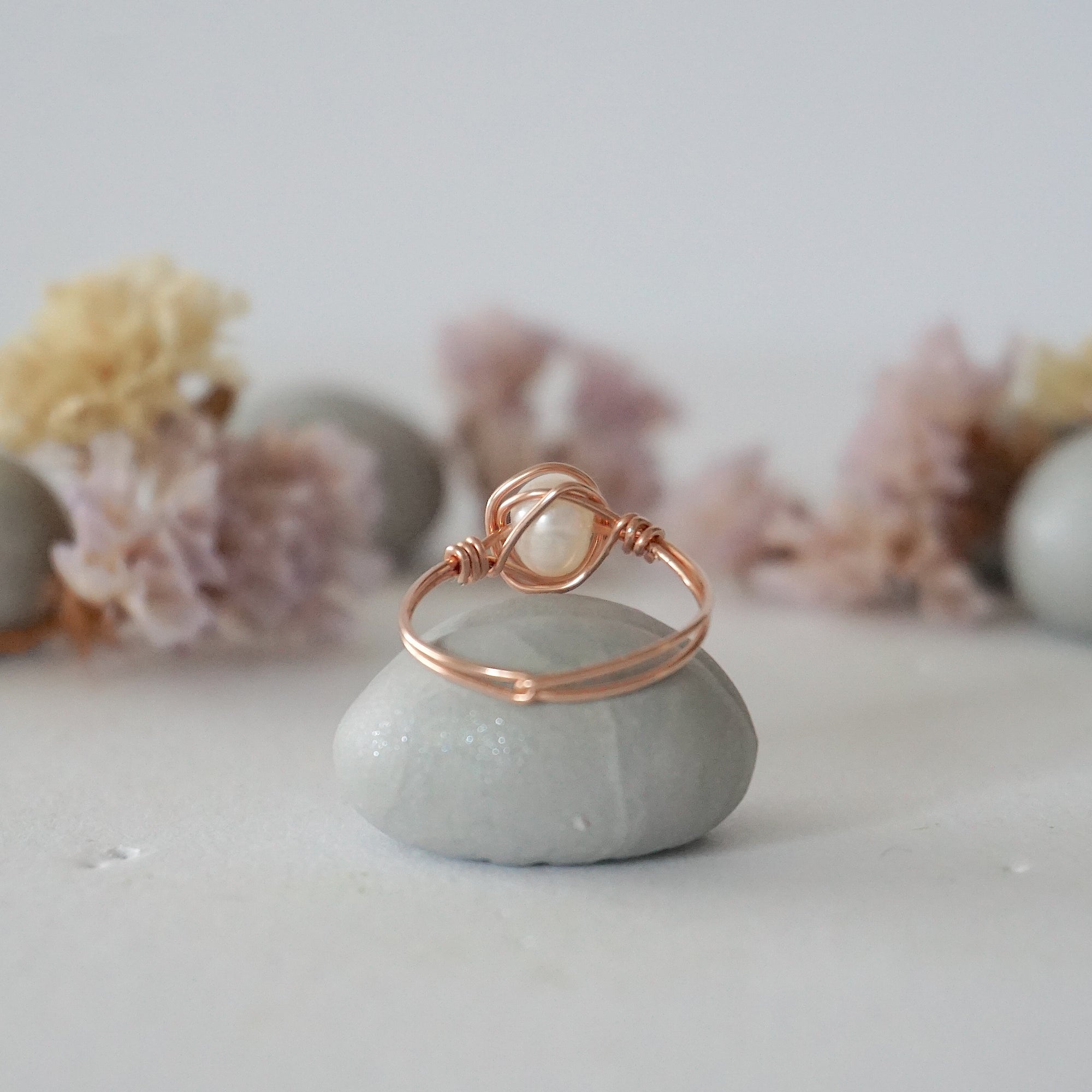 Back view of a minimalist pearl ring crafted in 14k rose gold filled wire