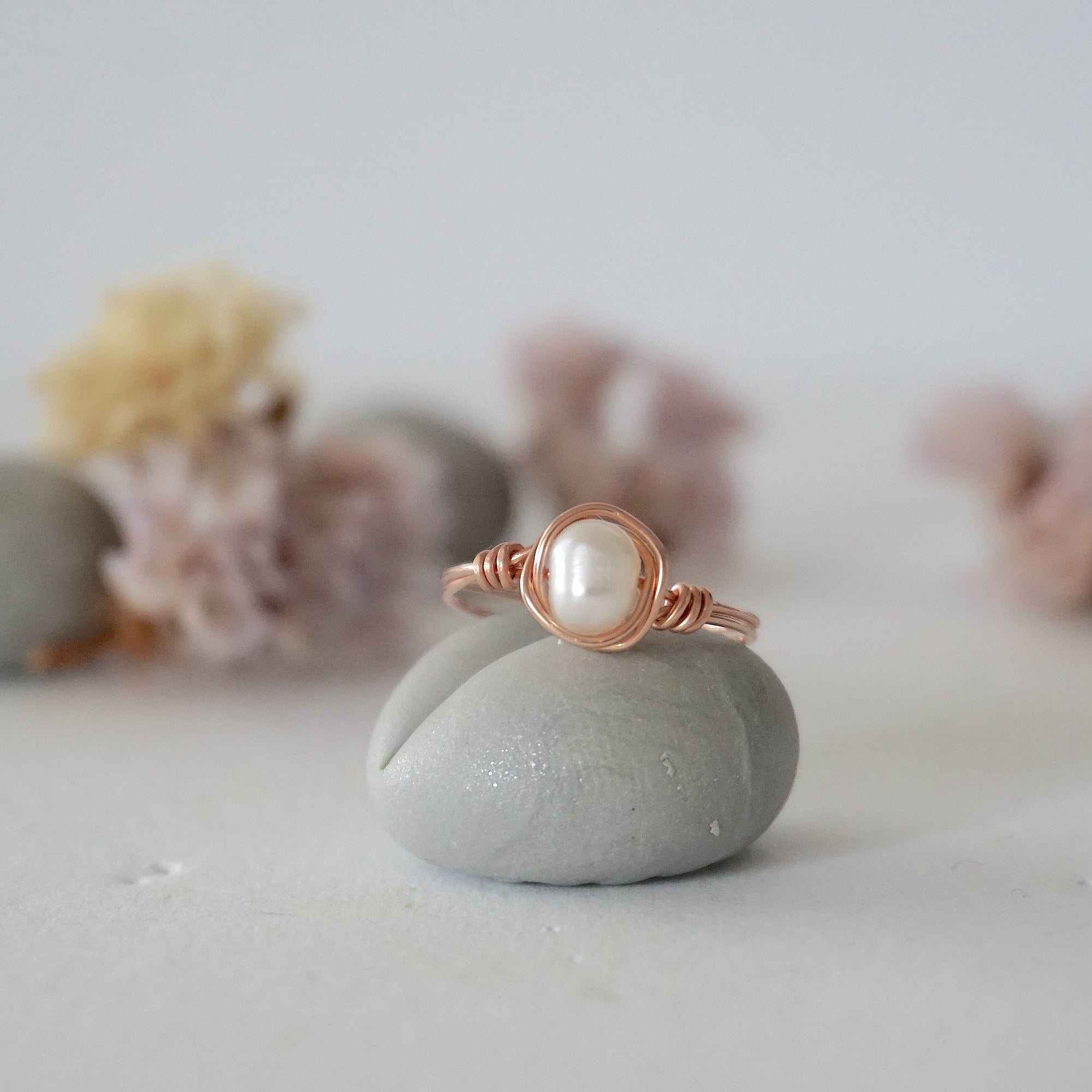 Front view of a minimalist pearl wire wrapped ring in 14k rose gold filled wire