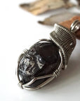 Left angle close-up of apache tears obsidian pendant – artisan wire wrapping, natural black stone, Designs by Nature Gems.