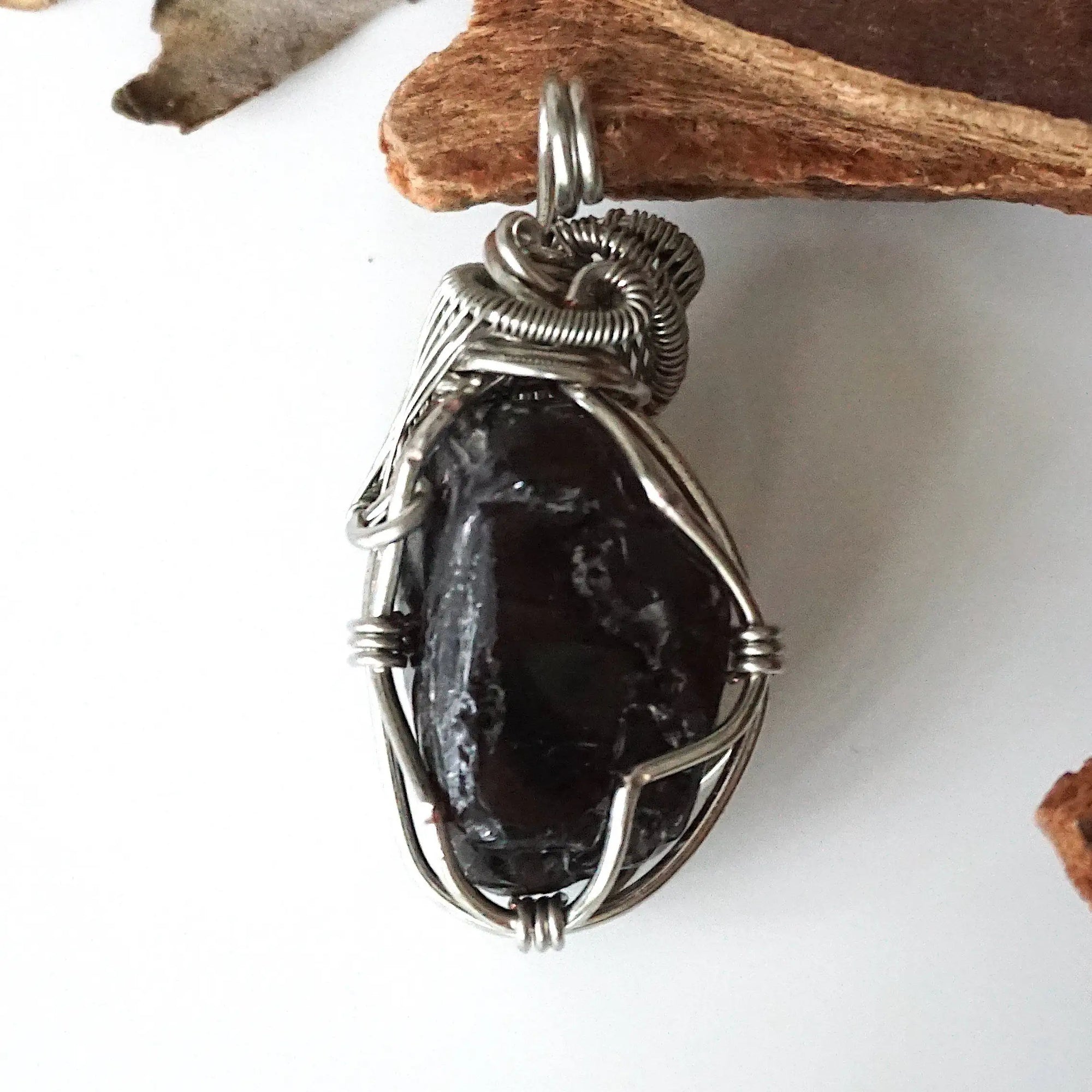 Back view of handcrafted apache tears obsidian pendant – natural volcanic glass and wire wrapping detail, Designs by Nature Gems.