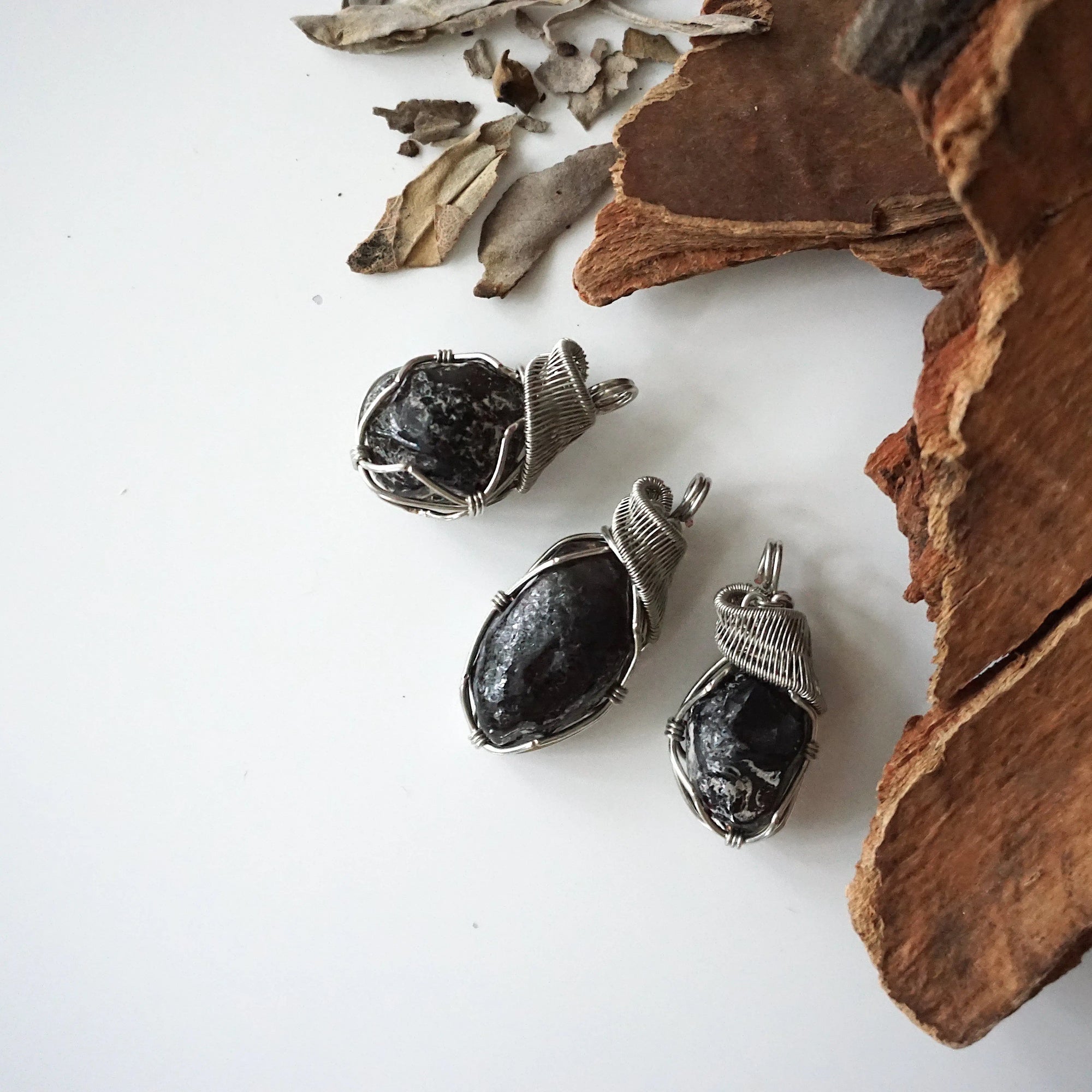 Three apache tears obsidian pendants – showing natural variation in size, shape, and color, handcrafted unisex volcanic glass jewelry.