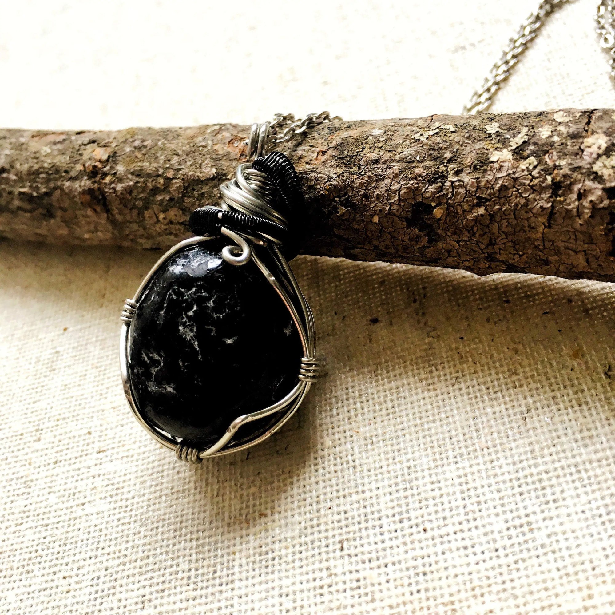 Back view of men's apache tears obsidian necklace – natural volcanic glass, detailed wire wrapping, white gold and black copper, Designs by Nature Gems.