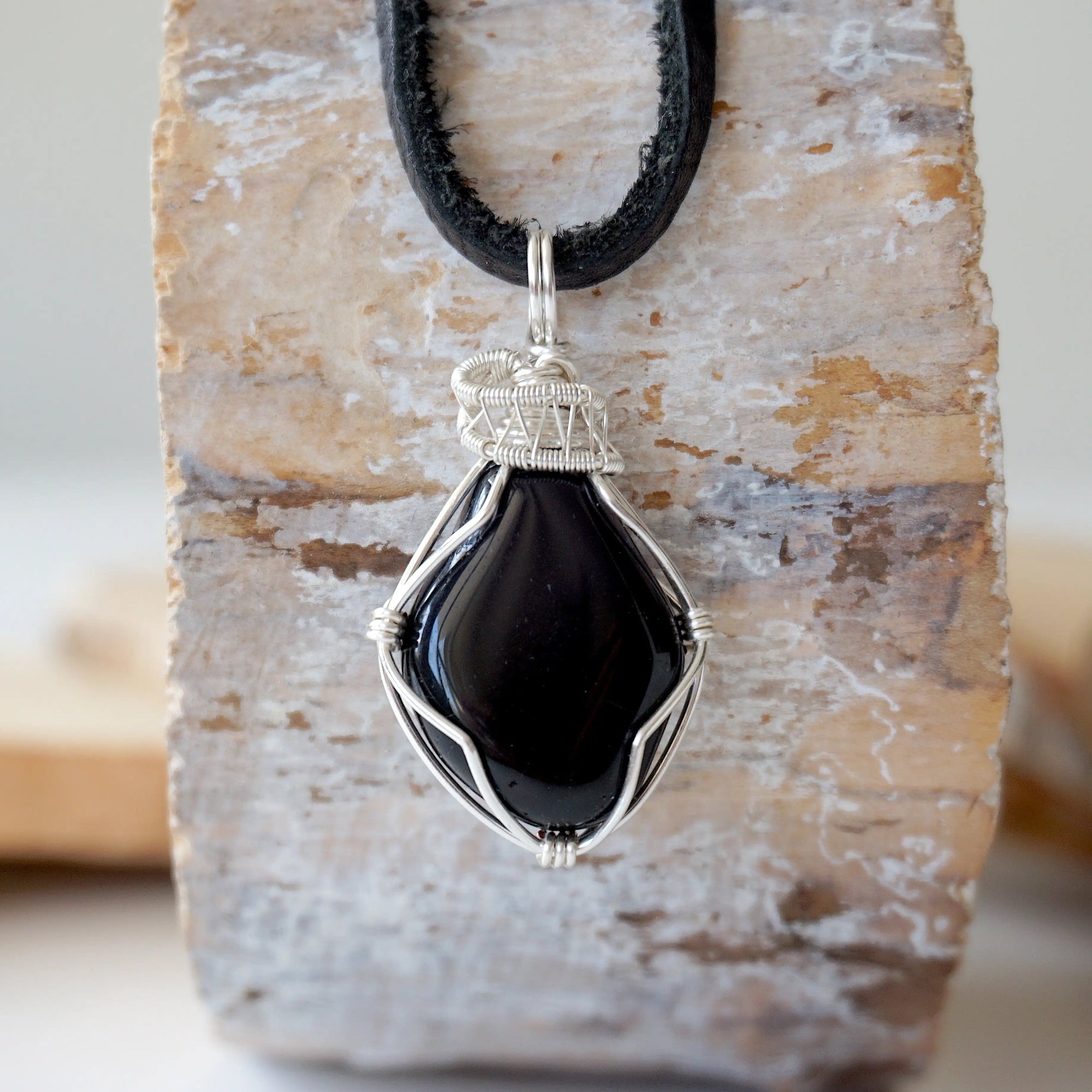 Handcrafted raw black onyx necklace for men, front view – artisan silver copper wire wrapping, July birthstone, flat black leather cord.