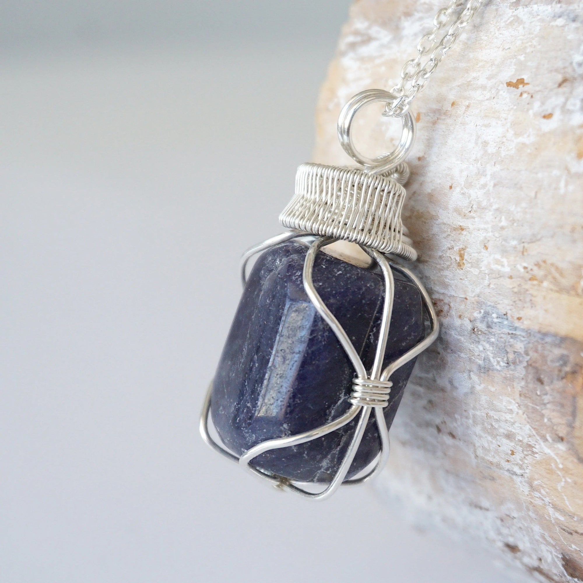 Left angle close-up of sapphire necklace for men – highlighting unique wire-wrapped artistry, blue sapphire, 925 sterling silver.