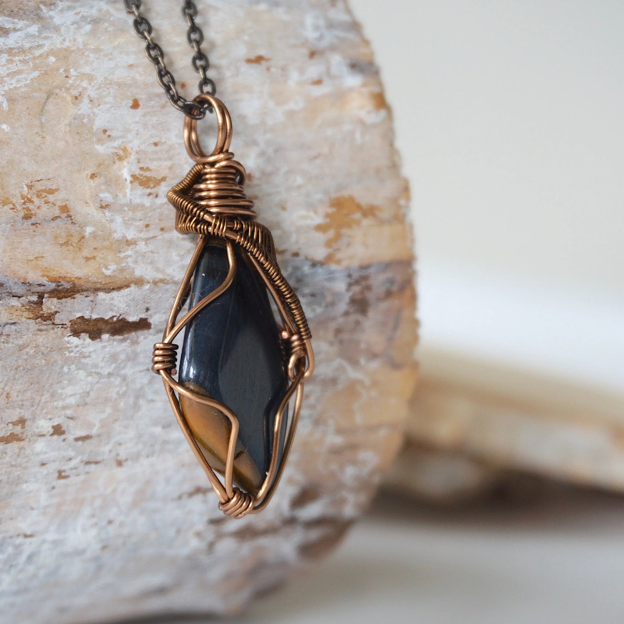 Right angle close-up of blue tiger's eye necklace for men – detailed antique bronze copper wire wrapping, natural crystal.