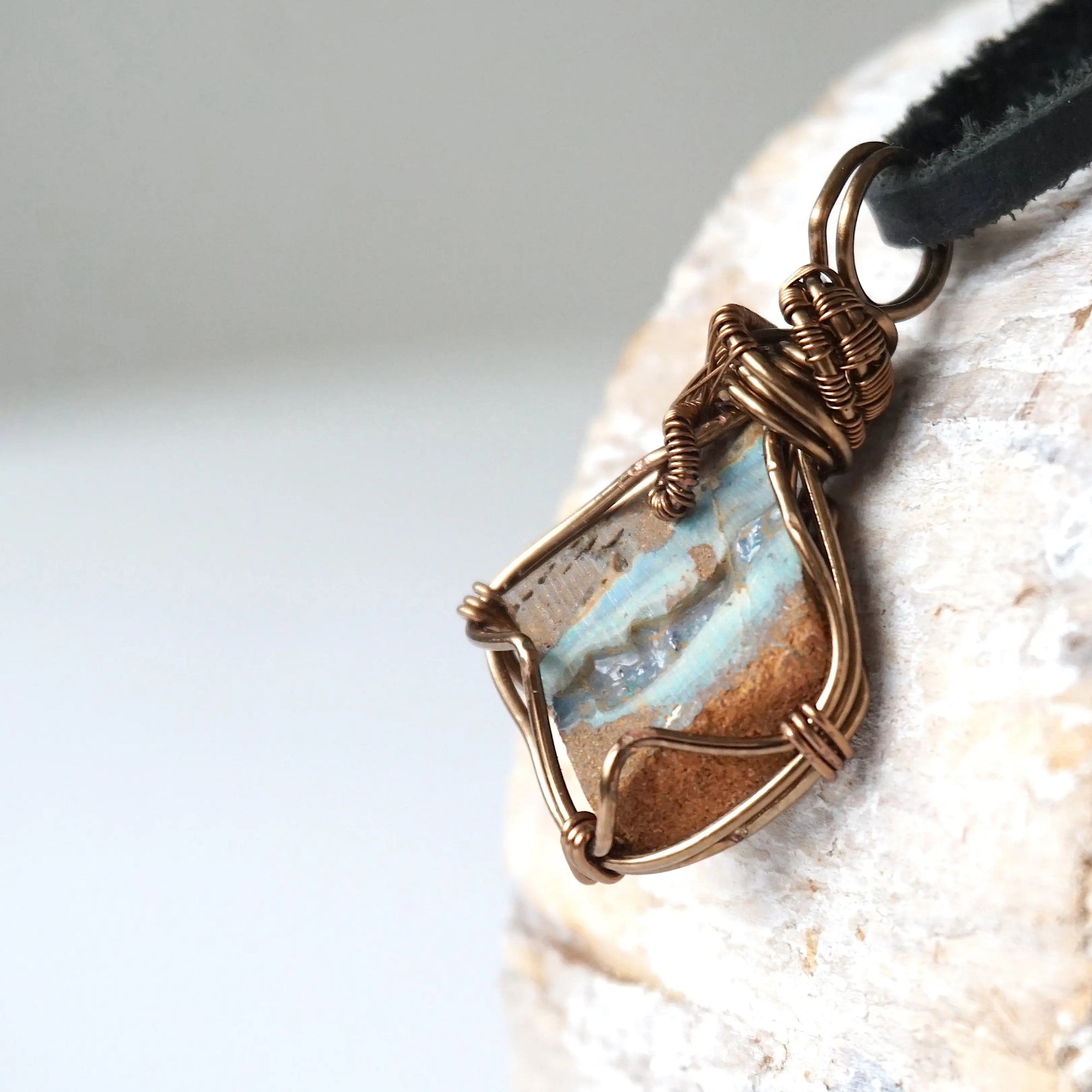 Left angle detail of Australian boulder opal necklace for men – highlights artisan bronze copper wire wrapping and natural stone colors.