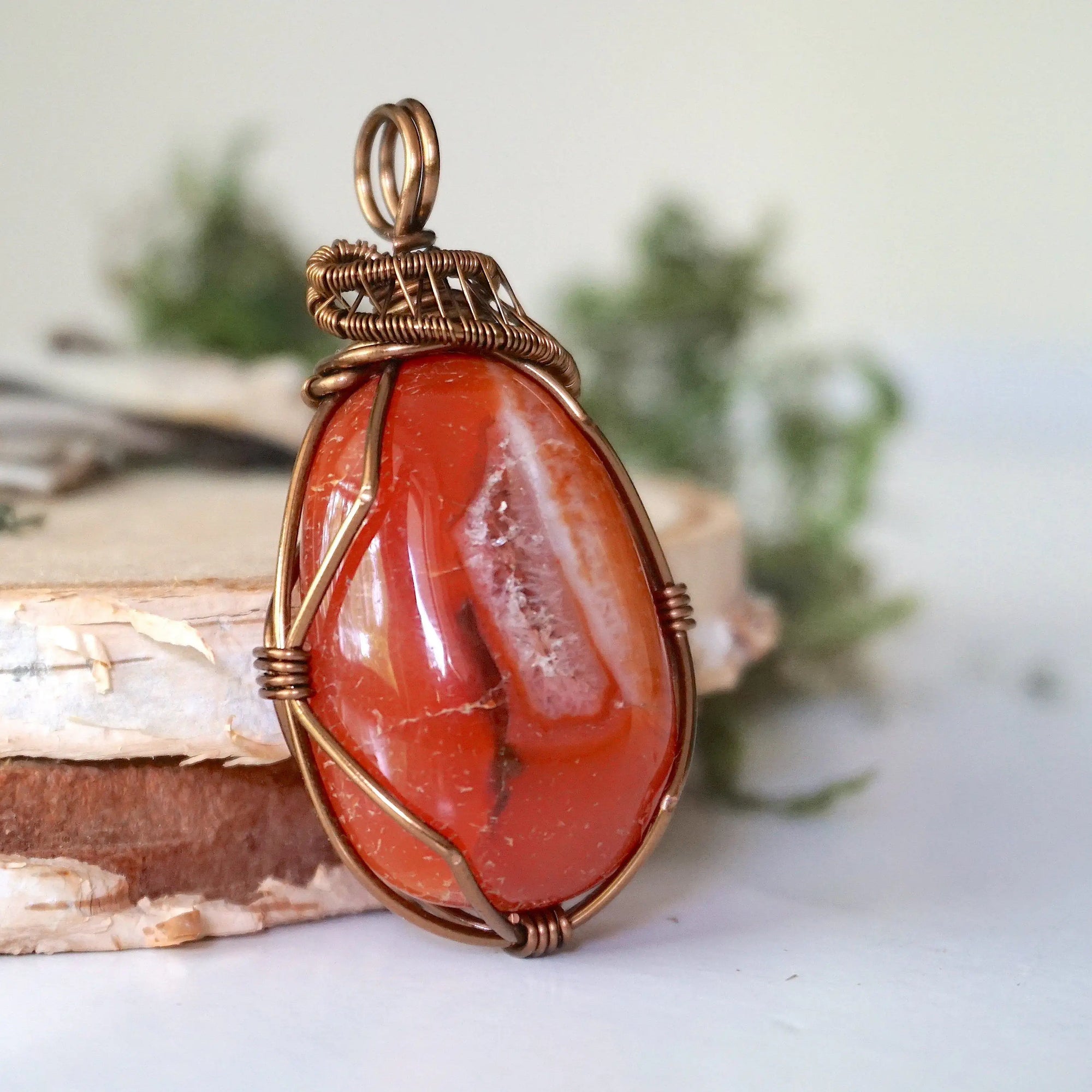 Right angle close-up of carnelian necklace – highlighting unique wire-wrapped artistry, raw carnelian, gender-inclusive jewelry.