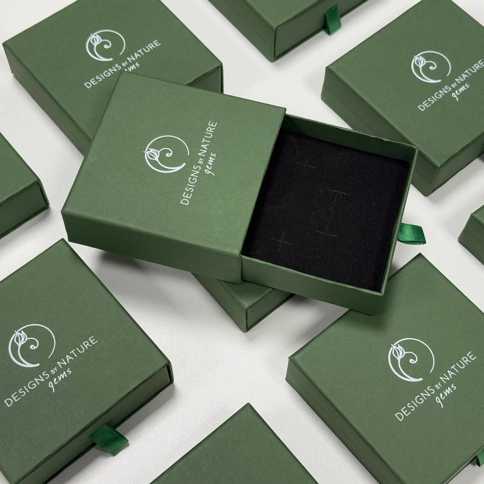 green box with designs by nature gems logo